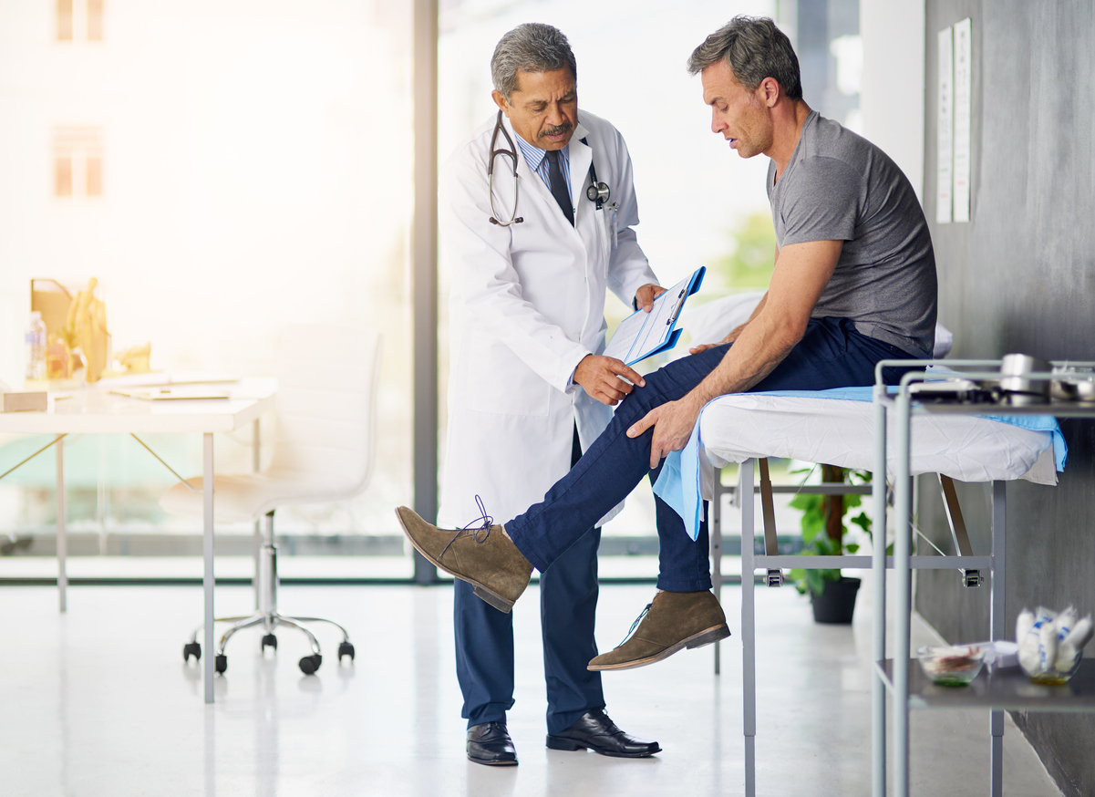 doctor and patient with leg pain
