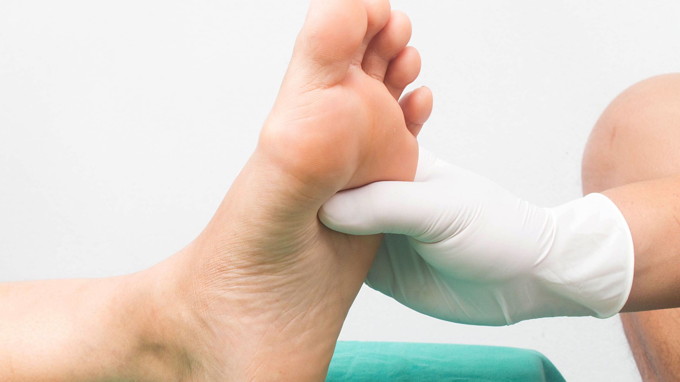 doctor checking foot for diabetic neuropathy